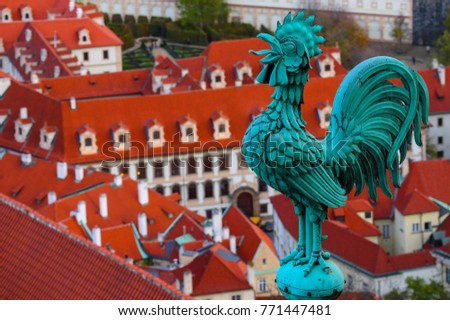 Weathercock on the roof, Czech, Prague, city view. Prague architecture, red roofs, weather vane shape of rooster.