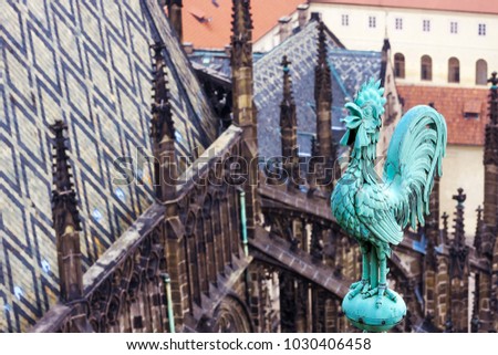 Weathercock on the St Vitus cathedral roof, Czech, Prague. Prague architecture, red roofs, weather vane shape of rooster.