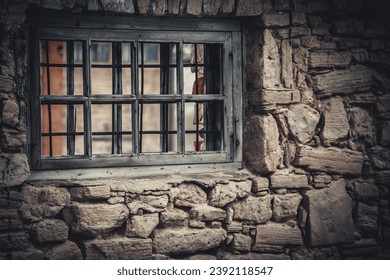 Weathered Abandoned Building Exterior with Damaged Walls and Old Windows. Place of imprisonment, Prison with the old window