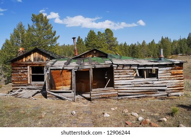 Weathered abandoned home in remote mountain meadow.