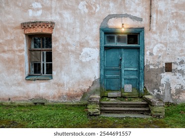 Weathered blue door and vintage window on abandoned building with rustic charm - Powered by Shutterstock