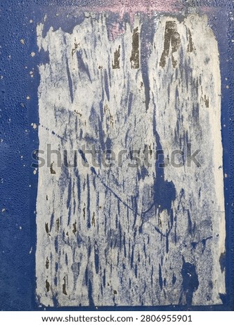 Weathered blue surface featuring a distressed white poster design, offering a textured background and excellent copy space for advertising and news content.