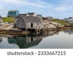 Weathered boathouse with dock in a cove on the shores of the Atlantic ocean.