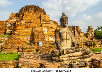 Weathered Buddha statue at Wat Mahathat, Buddhist temple in Ayutthaya, at Ayutthaya Historical Park, UNESCO World Heritage Site