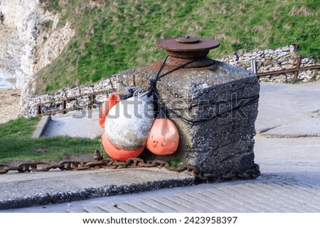 Weathered Buoys Tied to a Rustic Stone Pier