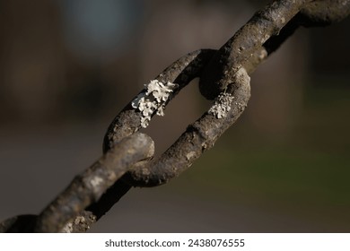 Weathered chain link with corrosion and rust close up