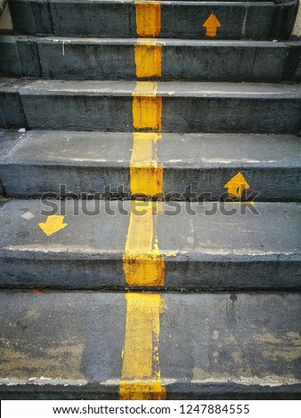 weathered cincrete staircase floor surface texture, yellow arrow sign on pedestrain bridge background Stock photo © 