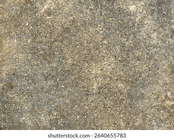 weathered concrete surface embedded with small gravel and pebbles, forming a rustic and gritty texture. The tones of grey and brown evoke an industrial and natural feel.