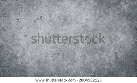 A weathered concrete surface with subtle texture and faint markings.