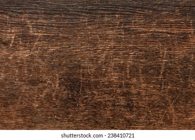 Weathered Dark Wood With Cracks And Scratches