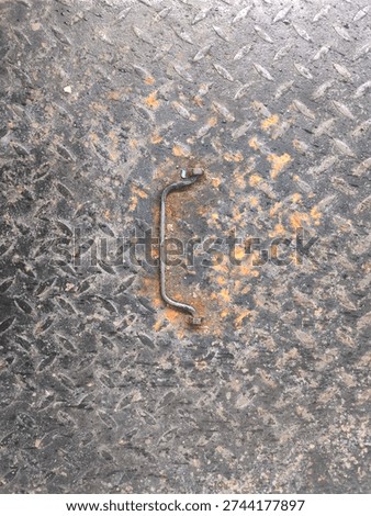 Weathered diamond pattern steel panel with corroded pull handle and chipped paint, rugged non slip tread texture background for industrial safety signage and repair themes