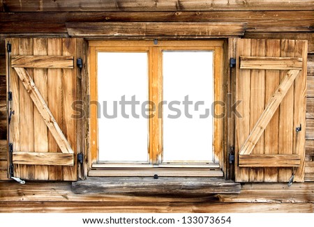 Weathered facade of a mountain hut with isolated windows