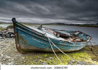 Weathered fishing boat lying on a rocky beach on the Isle of Lewis, Outer Hebrides, Scotland