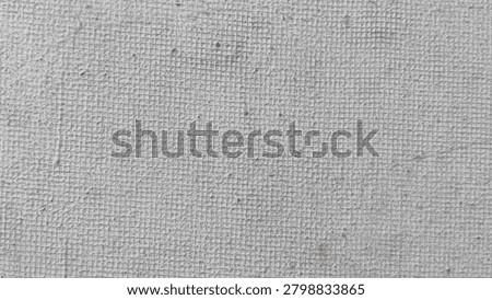 Weathered grey cement wall texture featuring a distinct grid pattern and a rough stippled surface finish.