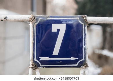 Weathered grunge square metal enameled plate of number of street address with number 7 - Powered by Shutterstock