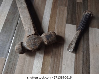 Weathered Hammer and Chisel Resting on a Wooden Floor