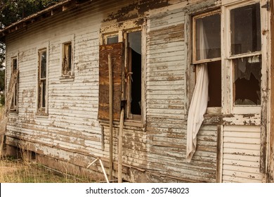 Weathered Industrial Exterior Design Clapboard Siding With Peeling Blue White Paint At Old Abandoned House Building With Open Window