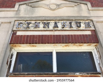 Weathered Lettering Above A Door To An Old Gymnasium