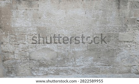 Weathered limestone ashlar wall texture in warm natural light