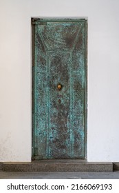 Weathered Metal Door In A  Facade Of Old House