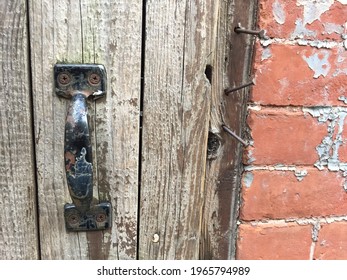 Weathered Metal Door Handle On Old Wood Door