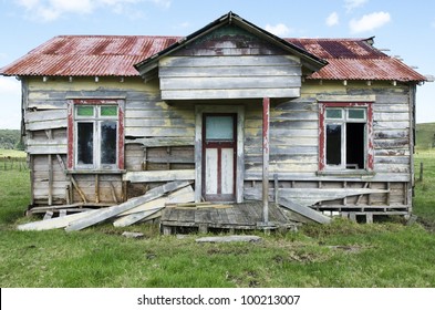 Weathered Old Deserted Falling Apart Traditional Wooden Farm House Cabin In Northland In The Top Of The North Island Of New Zealand. No People. Copy Space