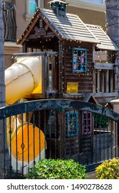 Weathered Old Playhouse Behind A Gate