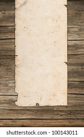 Weathered paper roll on vintage wooden background