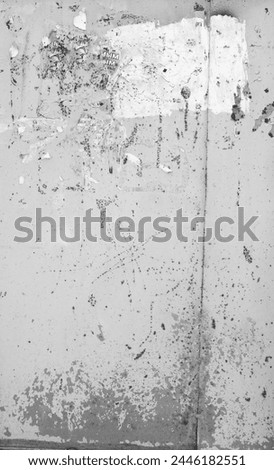 Weathered Poster Remnants On Urban Wall, Textured Grayscale Surface With Torn Layers