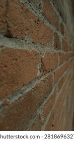 Close‑up of weathered red brick wall texture
Detailed view of rough terracotta bricks with uneven grey mortar, showing natural wear, cracks, and aged surface. Authentic historic masonry pattern and material detail.