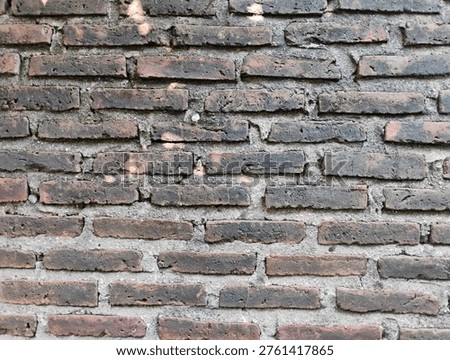 ​Old weathered red brick wall texture background with rough cement joints and vintage rustic feel.