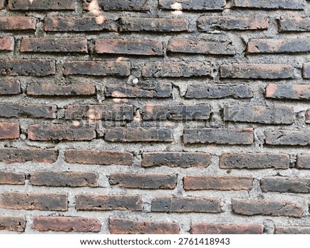 ​Old weathered red brick wall texture background with rough cement joints and vintage rustic feel.