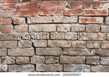 Weathered red brick wall with vertical crack brick texture cracked wall old background textured wal