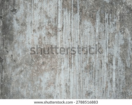 A weathered, rough concrete wall featuring heavy vertical water streaks, dark grime, and peeling paint.