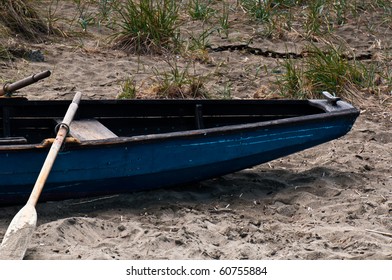 A weathered rowboat  on the beach at the Hyde Street Pier on the San Francisco waterfront. - Powered by Shutterstock