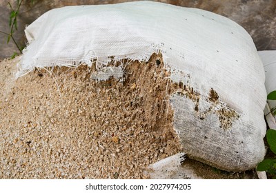 weathered and torn sacks filled with sand lying on the ground - Powered by Shutterstock