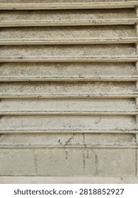Weathered ventilation slats from an old structure, covered in environmental dirt.