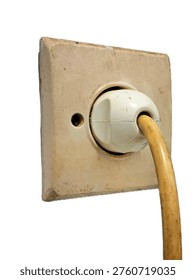 Weathered vintage electrical wall socket with power plug and thick hanging cable isolated on white background side view macro shot for home renovation construction and maintenance concept projects.