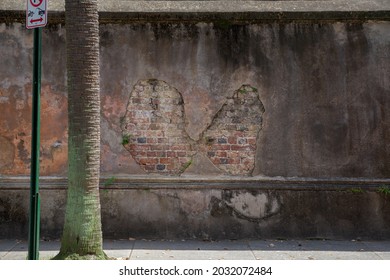 Weathered Wall With Brick Showing Through Hole In Plaster. Downtown Charleston, SC Texture.