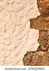 weathered whitewashed stone wall with exposed rustic masonry texture