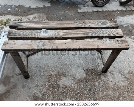 Similar – Image, Stock Photo A weathered wooden bench in front of a yellow painted wall