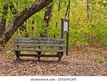 Weathered wooden bench at trailhead in autumn - Powered by Shutterstock