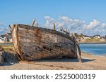 Weathered wreck of wooden fishing boat at Portbail, Cotentin peninsula, Normandy, France