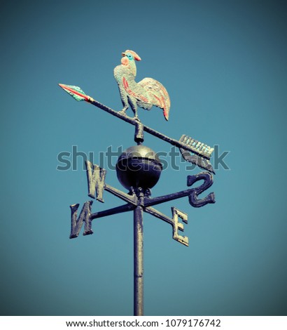 weathervane also called weathercock with vintage effect and blue sky on background