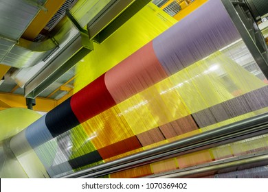 weaving loom at a textile factory, closeup. industrial fabric production line - Shutterstock ID 1070369402