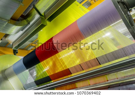 weaving loom at a textile factory, closeup. industrial fabric production line
