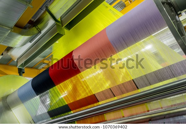 weaving loom at a textile factory, closeup.\
industrial fabric production\
line