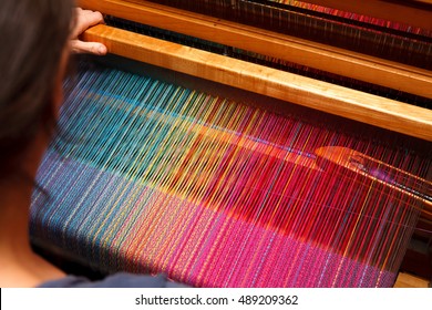 Weaving shuttle on the color warp - Shutterstock ID 489209362