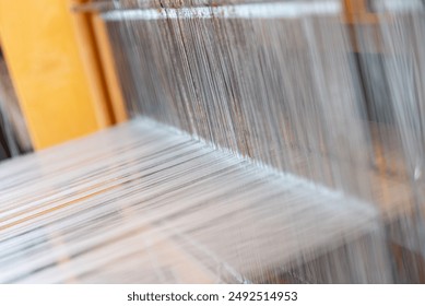 Weaving, traditional crafts,Close-up of a loom weaving, Woven silk,using cotton and silk string stretch and woven by using mechanic wooden machine to weave - Powered by Shutterstock