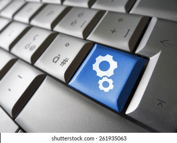 Web Account, Technology Support And Website Settings Concept With Two Gears Icon And Symbol On A Blue Laptop Computer Key For Internet And Online Business.